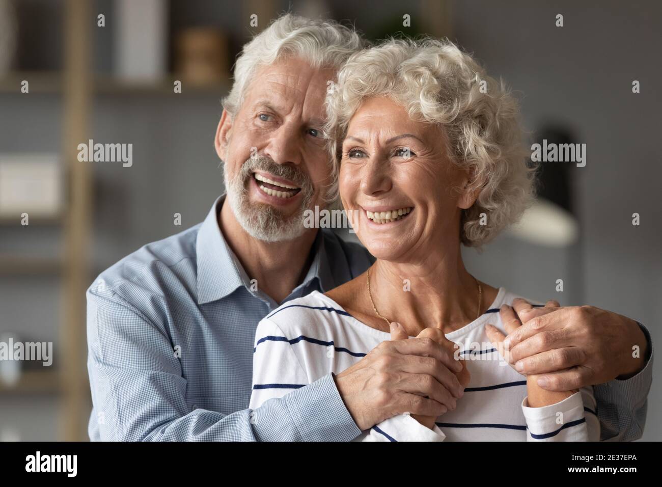 Sorridente vecchia coppia di famiglia di legame di mezza età che guarda in lontananza. Foto Stock