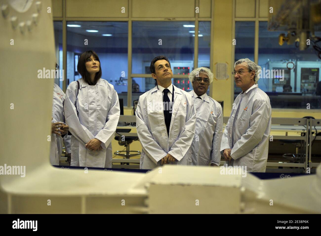 Il presidente francese Nicolas Sarkozy e la First Lady Carla Bruni-Sarkozy parlano con i funzionari indiani mentre visitano una "stanza bianca", presso il centro satellite dell'Organizzazione della ricerca spaziale indiana (ISRO) a Bangalore, in India, il 4 dicembre 2010, dove è costruito il satellite franco-indiano Megha-Tropiques. Sarkozy, che farà pressione per conto di società francesi che inseguono contratti indiani da miliardi di dollari per jet da combattimento e tecnologia nucleare, è accompagnato in quattro giorni dalla moglie Carla Bruni. Foto di Lionel Bonaventure/piscina/ABACAPRESS.COM Foto Stock