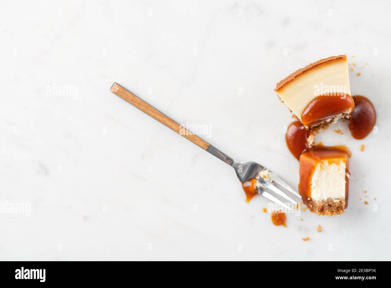 Fetta di cheesecake brocciata con salsa al caramello. Mangiare cheesecake processo Foto Stock