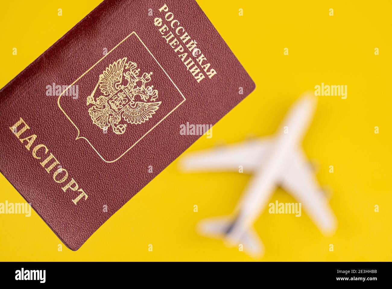 Aereo sul passaporto russo. Concetto di viaggio. Sfondo giallo. Foto Stock