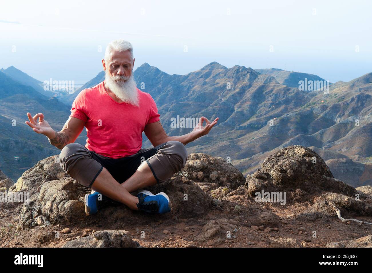 Uomo anziano saluto tramonto Foto Stock