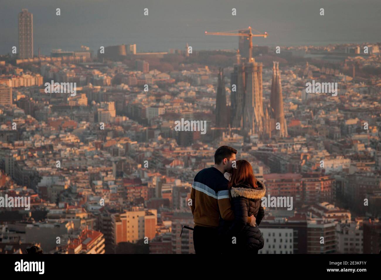 Un bacio di coppia in cima al punto panoramico del Turo de la Rovira con la Sagrada Familia e la città di Barcellona sullo sfondo. Foto Stock