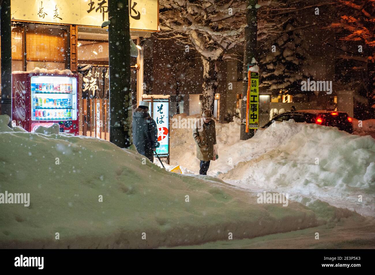 Forte nevicata nella città giapponese. Scena notturna di fronte al ristorante Soba. Foto Stock