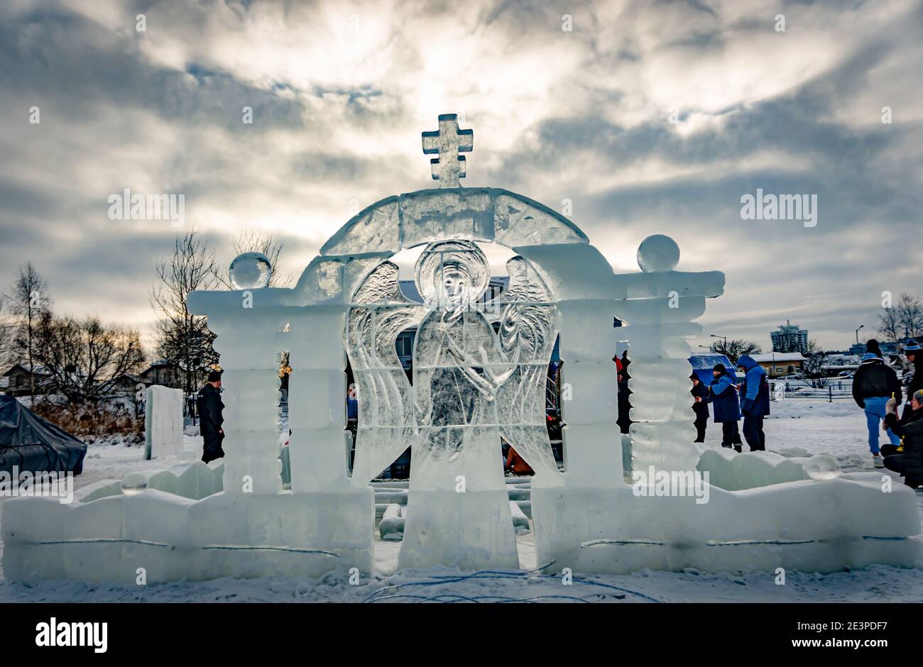 Font per immergere in un buco di ghiaccio per il battesimo di cristo e scultura del ghiaccio in forma di an angel e una croce Foto Stock