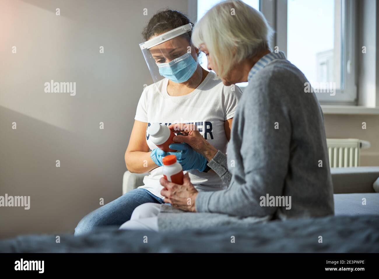 Due donne focalizzate che leggono le etichette di vitamina Foto Stock