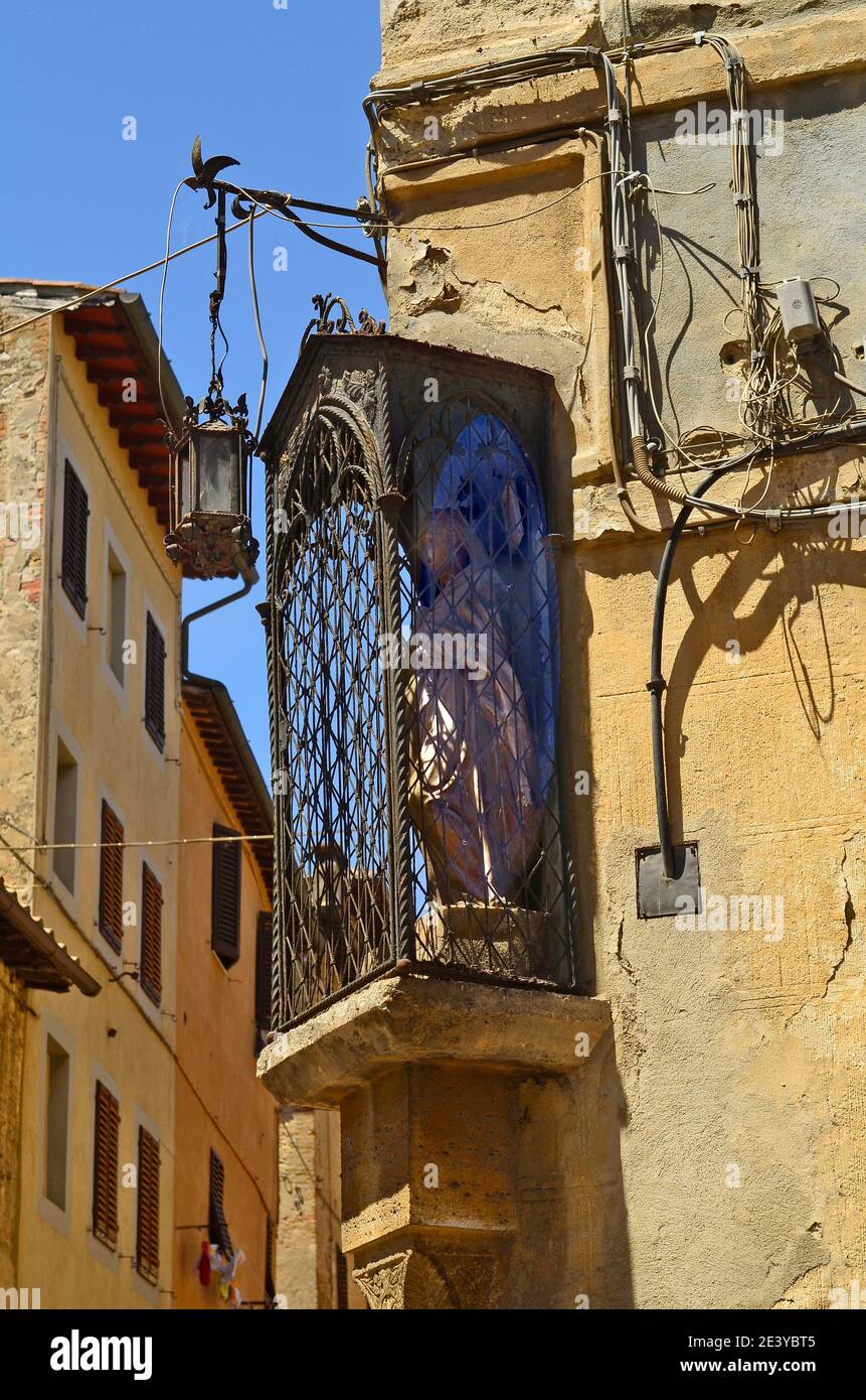 Italia, patrono su un muro nel sito patrimonio dell'umanità dell'UNESCO di San Gimignano in Toscana Foto Stock
