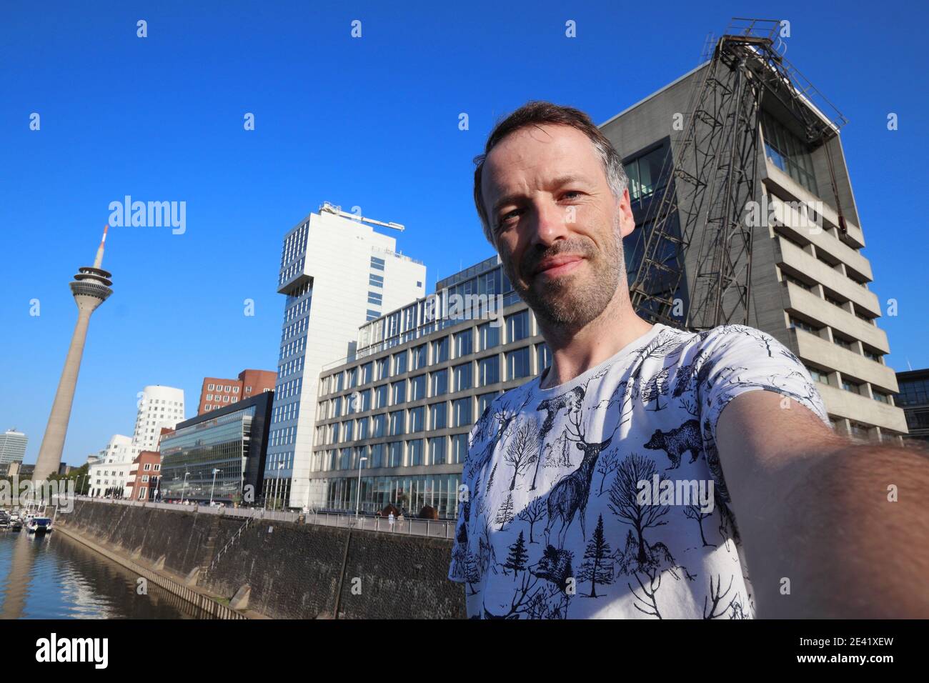 Selfie turistico a Dusseldorf, Germania. Selfie viaggiatore con lo skyline moderno di Dusseldorf Hafen. Foto Stock