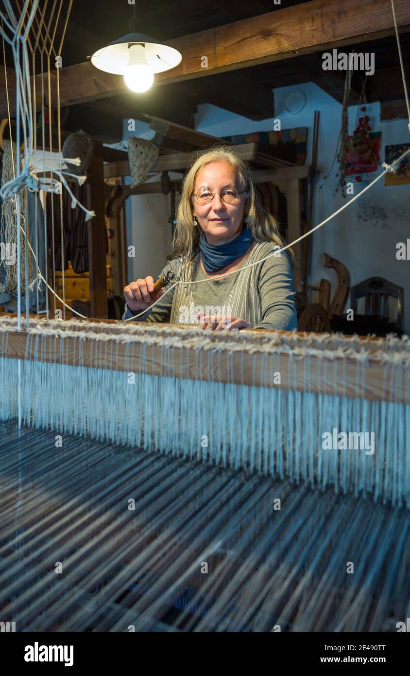 Batzlow, Germania. 07 gennaio 2021. Costanze Büxler, proprietario di Urticahof, lavora in un telaio. Al centro di Märkische Schweiz, i tappeti e i tessuti sono realizzati secondo le specifiche del cliente sui telai a mano. Nei corsi i visitatori possono imparare l'feltraggio, la filatura o la tintura con materiali naturali. Le vecchie tecniche artigianali sono affascinanti, ma non sono più redditizie. Credit: Patrick Pleul/dpa-Zentralbild/ZB/dpa/Alamy Live News Foto Stock