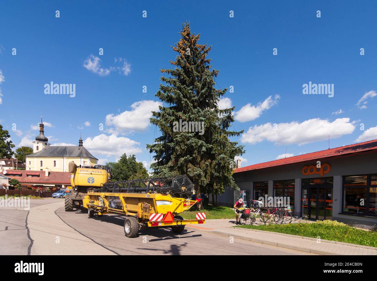 Bobrova (Bobrau), chiesa e veicoli agricoli di passaggio a Vysocina, Regione Hochland, ceco Foto Stock