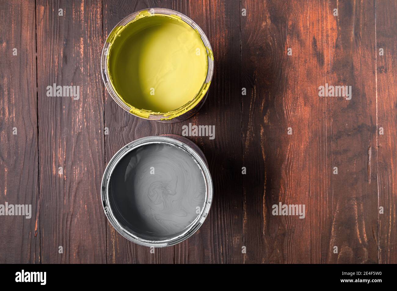 Lattine con vernice di grigio estremo e colore illuminante su sfondo di legno marrone. Colori di 2021 anni. Copiare spazio per il testo. Disposizione piatta. Foto Stock