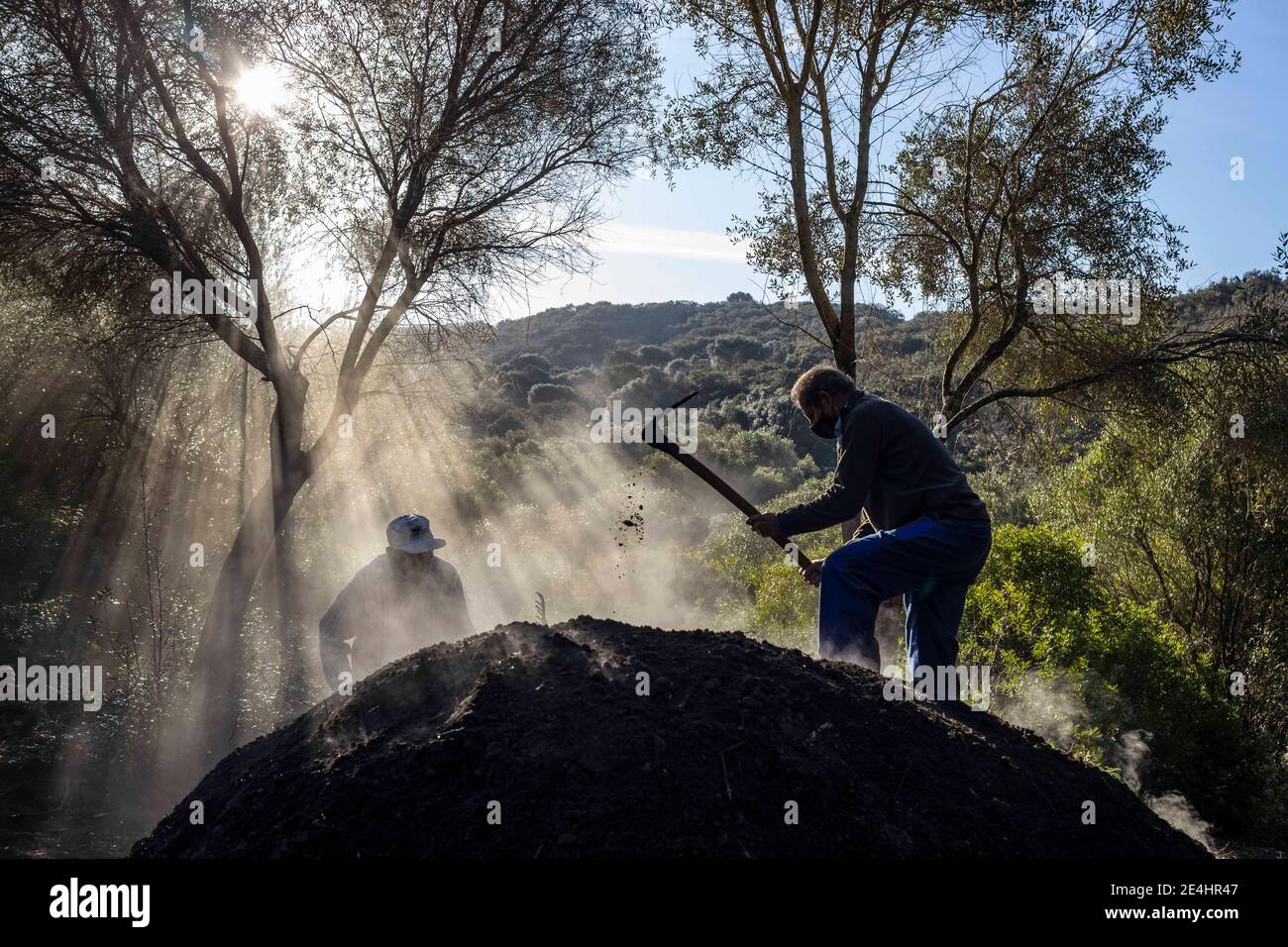 Bruciatori di carbone che lavorano in un forno di carbone che brucia Foto Stock