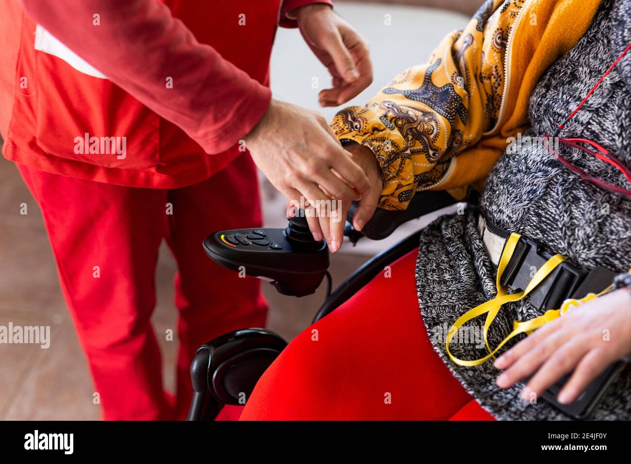 Infermiera maschile con donna disabile in casa di cura Foto Stock Infermiera maschile con donna disabile in casa di cura Foto Stock