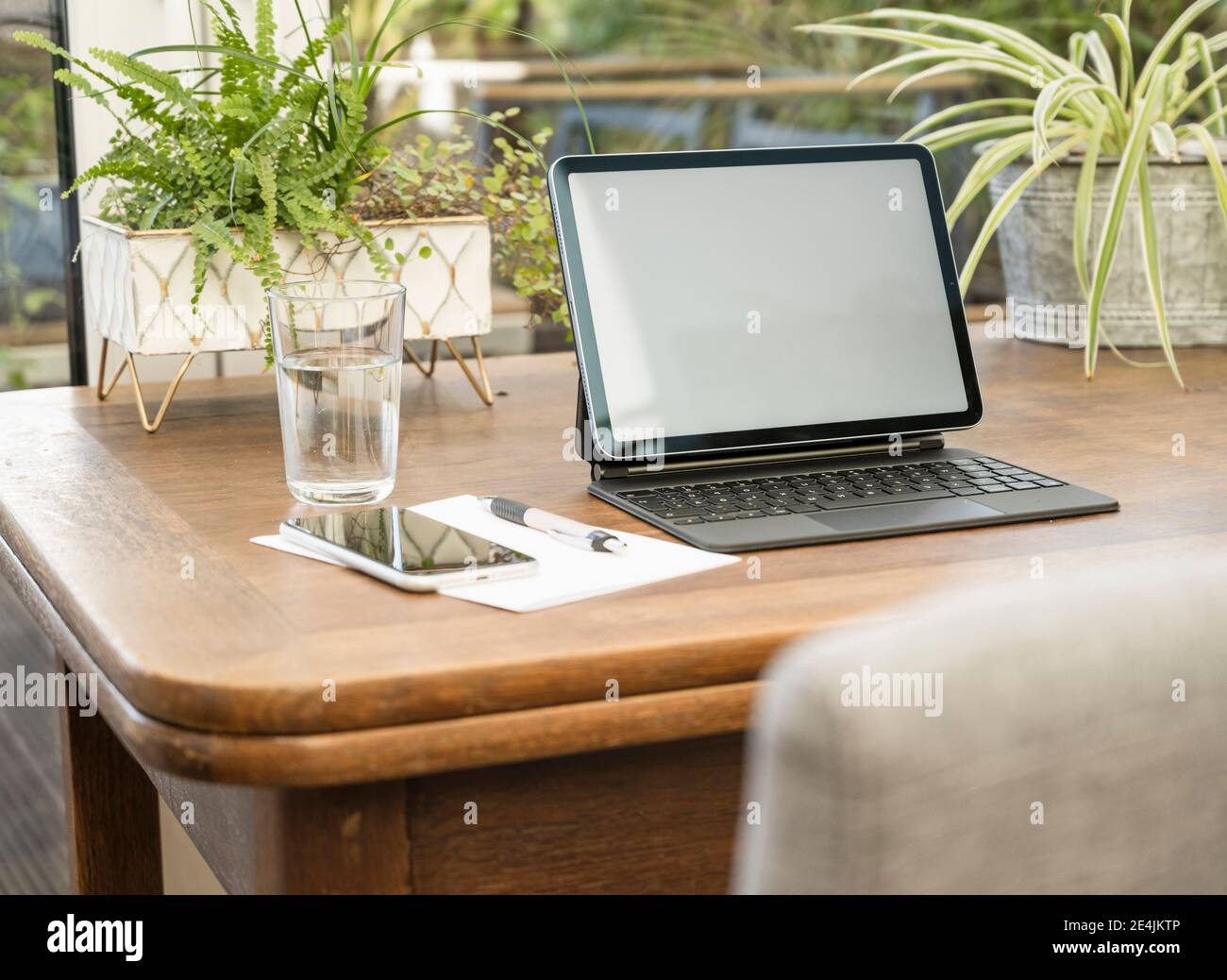 Tecnologia wireless con penna e carta per vetro sul tavolo a casa Foto Stock