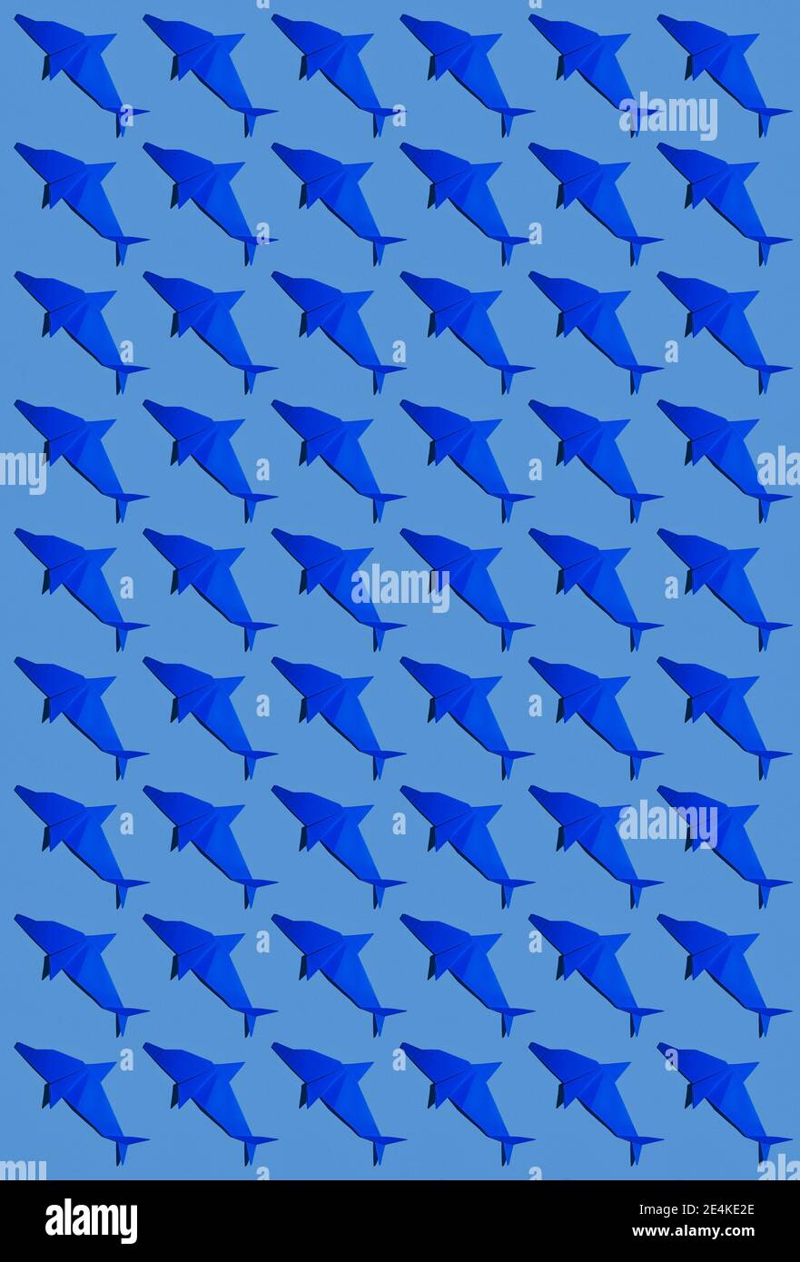 Origami di delfino blu disposti su sfondo colorato Foto Stock