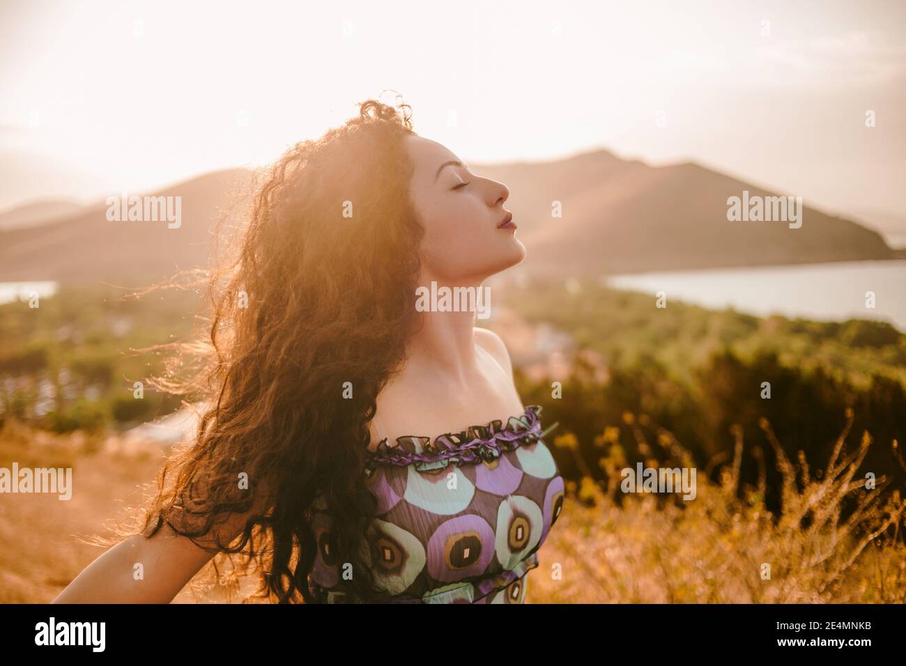 Stile di vita di ragazza riccia capelli godendo la luce del sole in estate Foto Stock