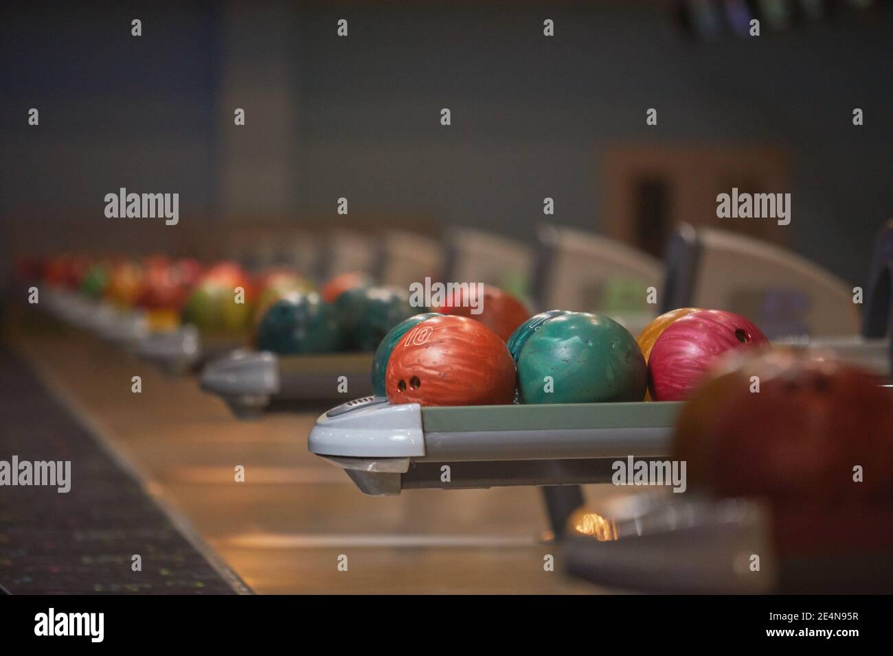 Immagine grafica di sfondo di macchine di ritorno palla e palla da bowling in fila al centro di intrattenimento, spazio di copia Foto Stock
