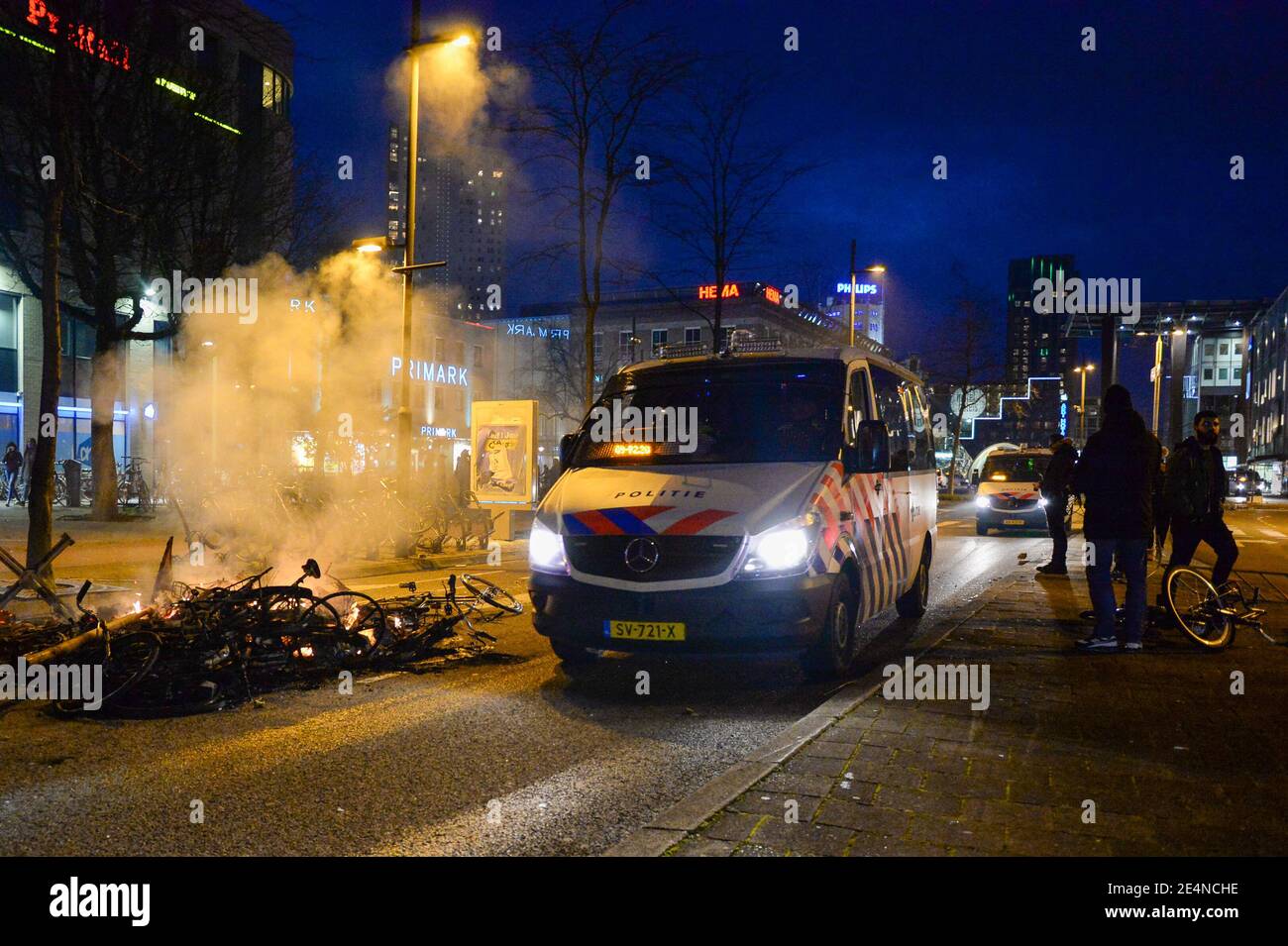 EINDHOVEN, PAESI BASSI - GENNAIO 24: La polizia è vista nei pressi di un mucchio di biciclette nel centro della città vicino alla stazione centrale di Eindhoven il 24 gennaio 2021 a Eindhoven, Paesi Bassi, dopo una protesta proibita contro le misure del coronavirus trasformate in rivolte. La polizia ha sgombrato la zona in e intorno alla stazione centrale dopo che i tiratori hanno saccheggiato un supermercato e si sono posti in primo piano per un'auto. (Foto di Joris Verwijst/BSR Agency/Alamy Live News) Foto Stock