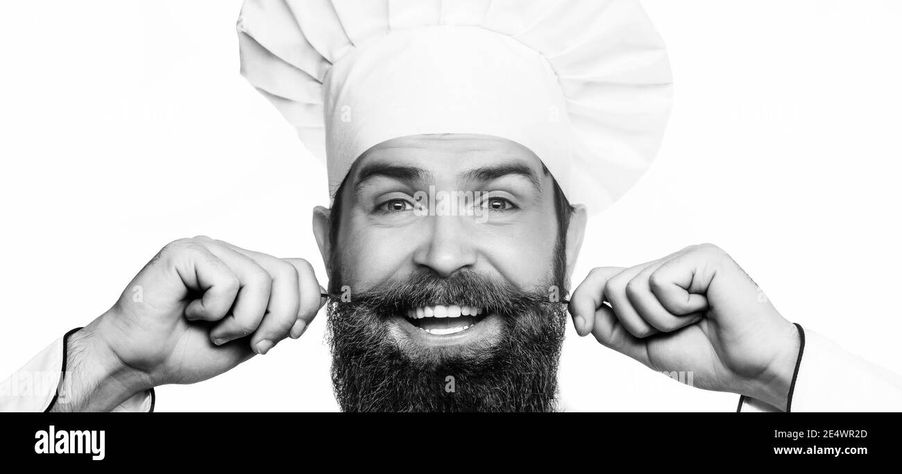Closeup faccia di un cuoco in un cappello. Chef divertente con cuoco per la barba. Ritratto di un cuoco chef felice. Bianco e nero Foto Stock