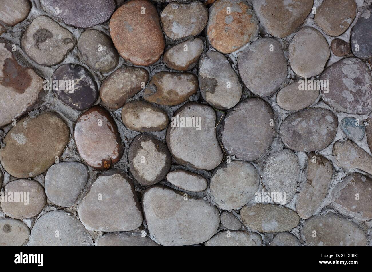 Struttura stradale in pietra. Ciottoli. Antico pavimento in pietra, forma ovale, vista dall'alto Foto Stock