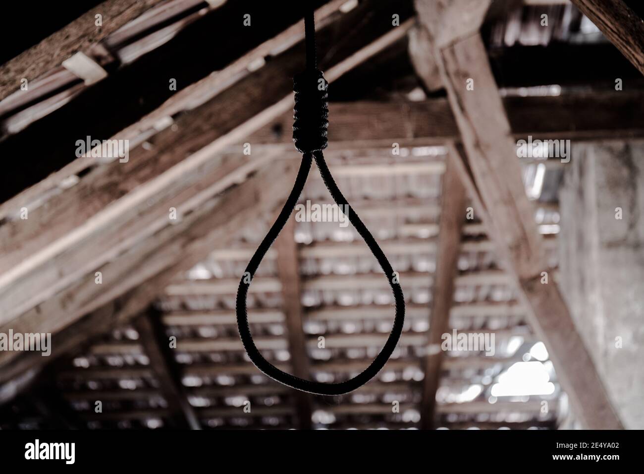 Un cappio appeso intorno al collo, un suicidio commesso, scene orribili in un soffitta oscura Foto Stock