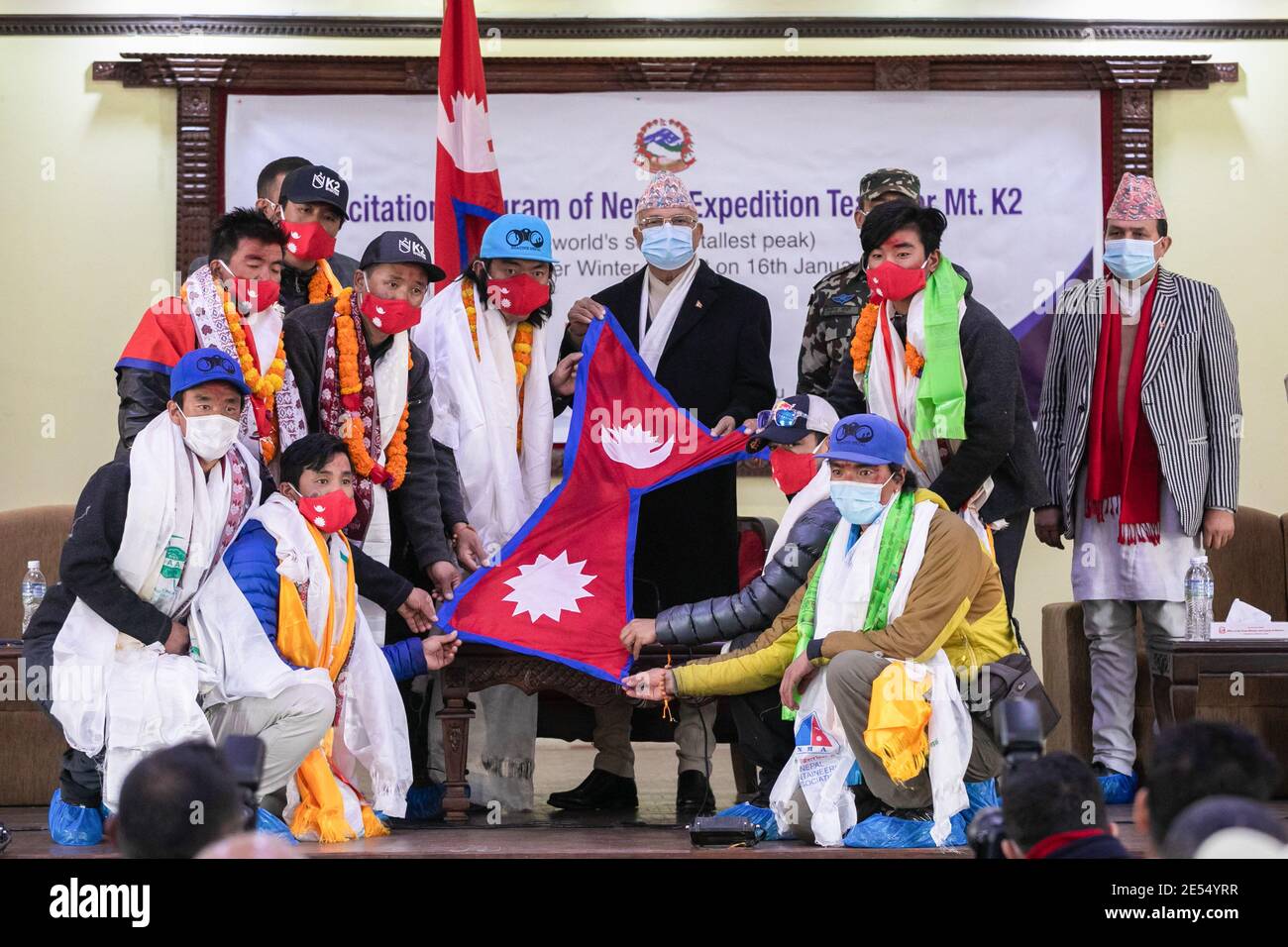 Il primo ministro nepalese KP Sharma Oli (C) e la squadra di alpinismo nepalese indossano maschere pongono ai media durante un felice programma di 10 membri della squadra di alpinismo nepalese del primo ministro del Nepal che ha fatto storia nella terza settimana di gennaio diventando il primo a scalare la worldís Seconda montagna più alta, Pakistanís K2 nella stagione invernale. Il 16 gennaio, una squadra di 10 nepalesi Mingma Gyalje Sherpa, Nirmal Purja, Mingma David Sherpa, Gelje Sherpa, Sona Sherpa, Mingma Tenzi Sherpa, PEM Chhiri Sherpa, Dawa Temba Sherpa, Kili Pemba Sherpa e Dawa Tenjing Sherpa hanno fatto pugno Foto Stock