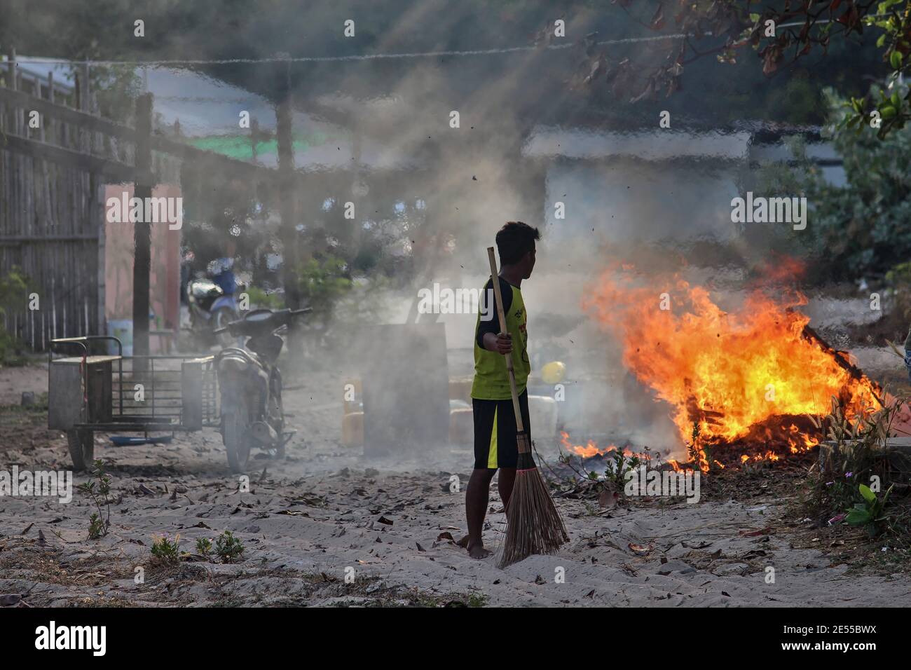 Chon Buri, Thailandia - 16 febbraio: I lavoratori cambogiani si levano in guardia contro gli incendi quando bruciano e distruggono i rifiuti nell'area di lavoro il 16 febbraio 2015. Foto Stock