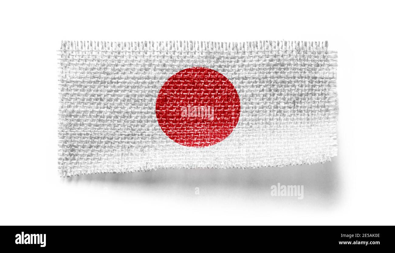 Bandiera del Giappone su un pezzo di stoffa su un bianco sfondo Foto Stock