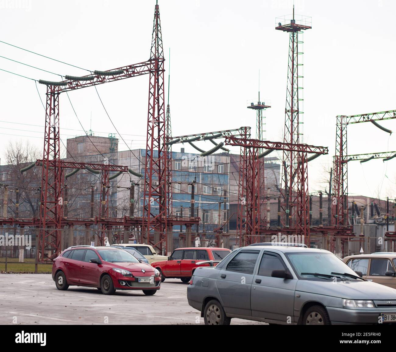 parcheggio auto sotto linee elettriche. impianto industriale. Foto Stock