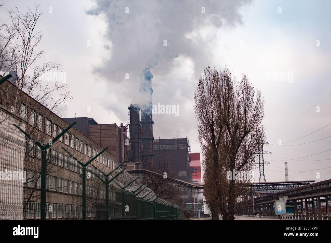 Zona industriale. Inquinamento atmosferico da fumo proveniente da due camini di fabbrica. Foto Stock