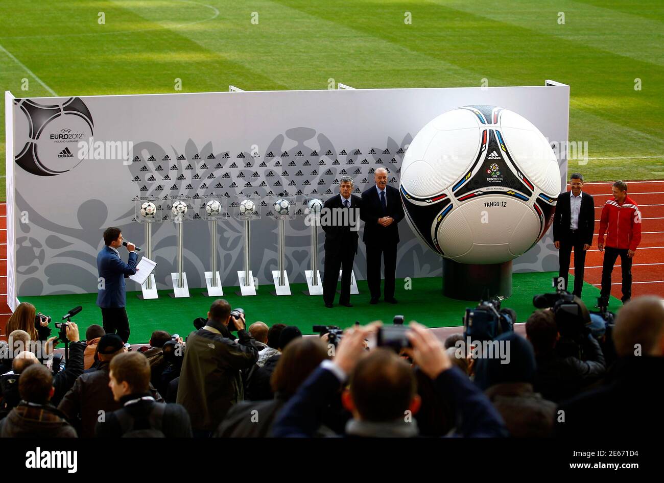 CEO of German sports manufacturer Adidas, Herbert Hainer (R) and Spain's  soccer team coach Vicente del Bosque (L) unveil a giant model of the  official match ball for the upcoming Euro 2012