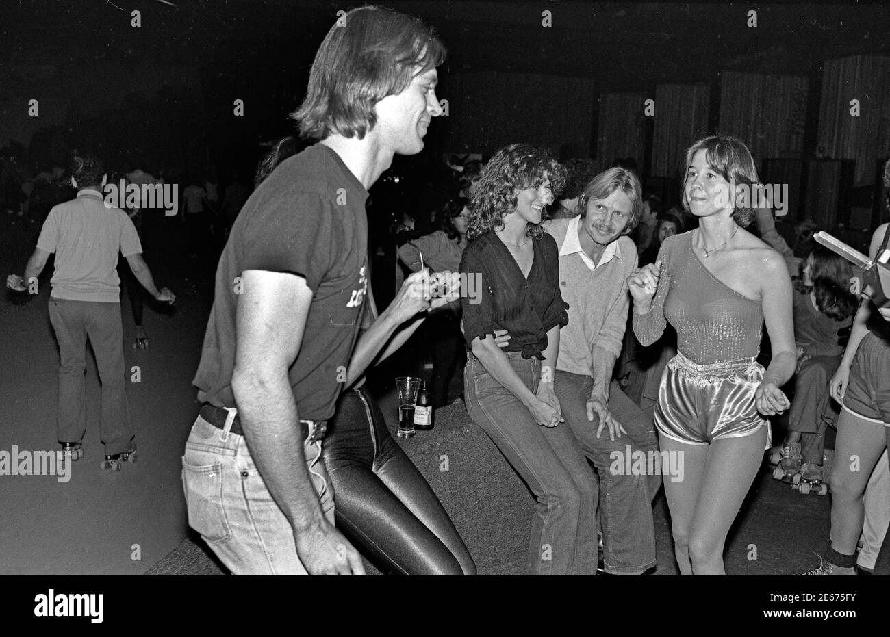 Keith Carradine skates Past Jon Voigt al Flippers Roller disco evento a sostegno di era, Los Angeles, ottobre. 29, 1978 Foto Stock