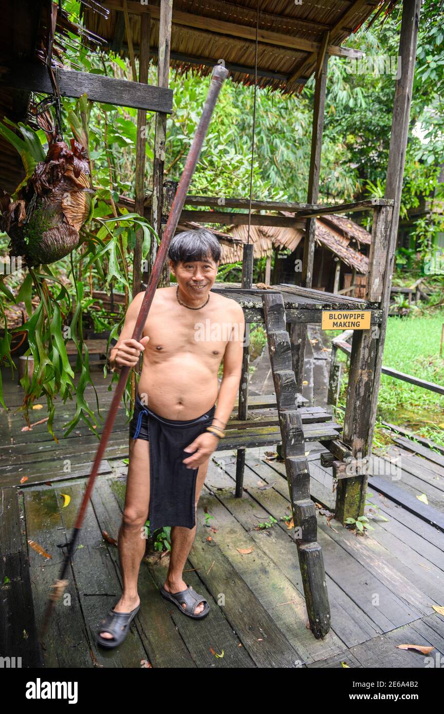 Orang Ulu uomo in abiti nativi che reggono un soffio tubo Foto Stock