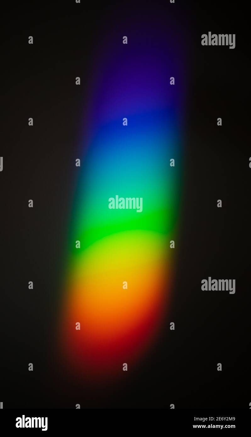 Effetto spettro colore arcobaleno sulla parete, diffusione della luce dopo aver colpito l'oggetto di vetro su una parete scura. Foto Stock