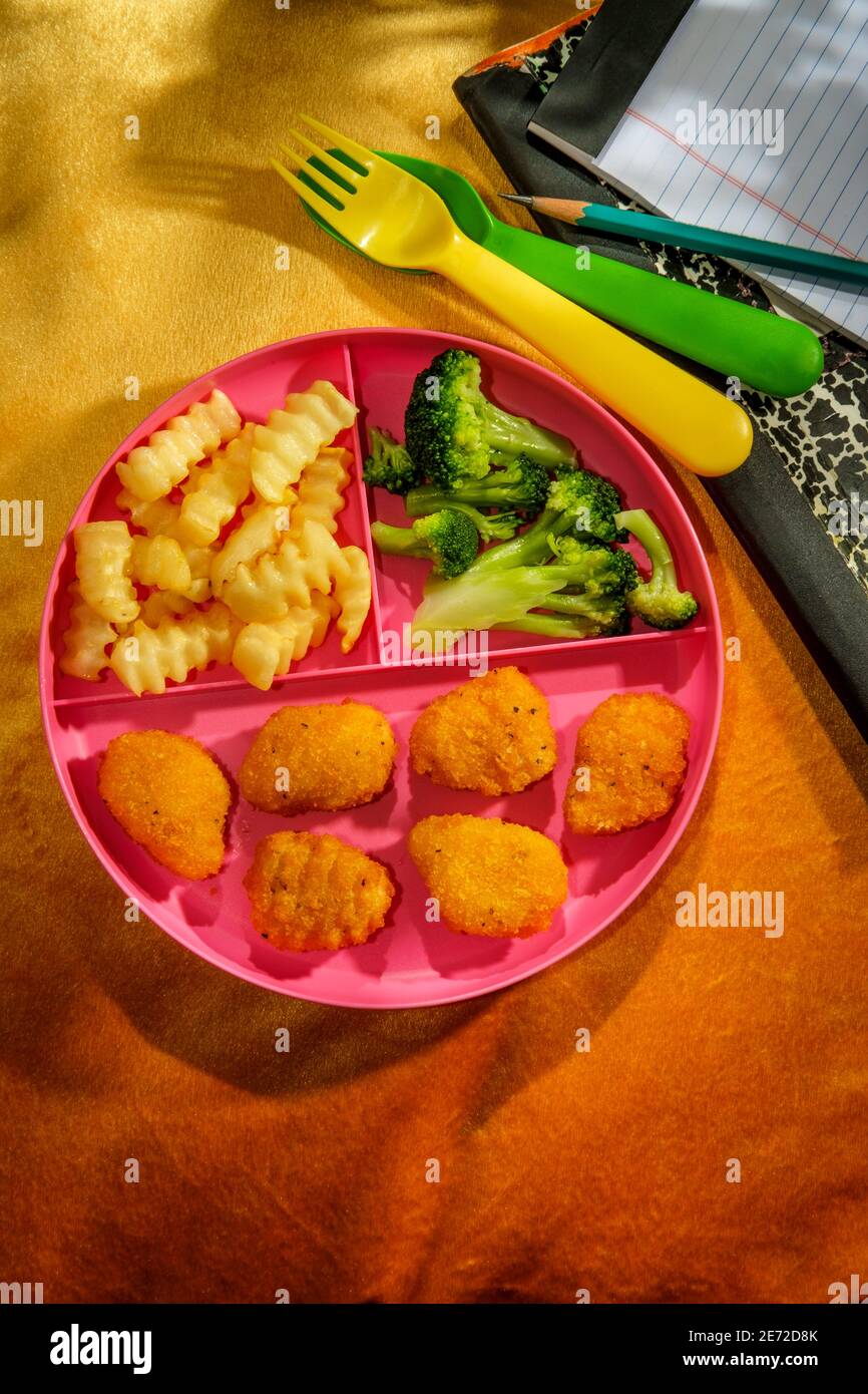 A casa scuola di pollo nugget pranzo servito su vassoio con patatine fritte e broccoli Foto Stock