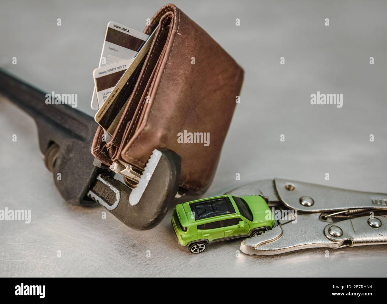 Intrappolato il pieno riempito di carte di credito portafoglio è catturato nelle mascelle della chiave, così è la macchina in miniatura Foto Stock