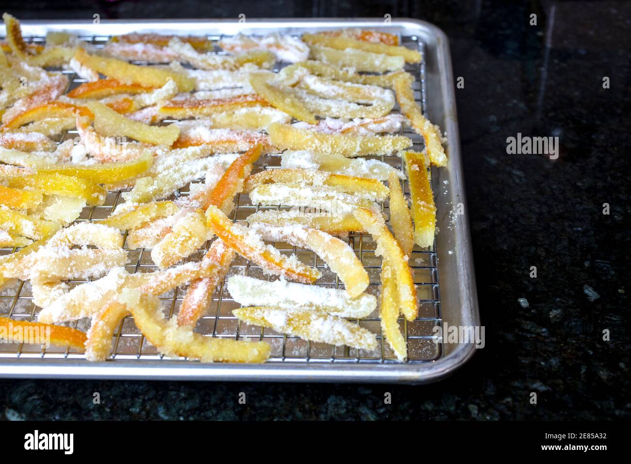 Bucce candite di arancia e limone riposante in una padella a. asciugare fino al completamento Foto Stock