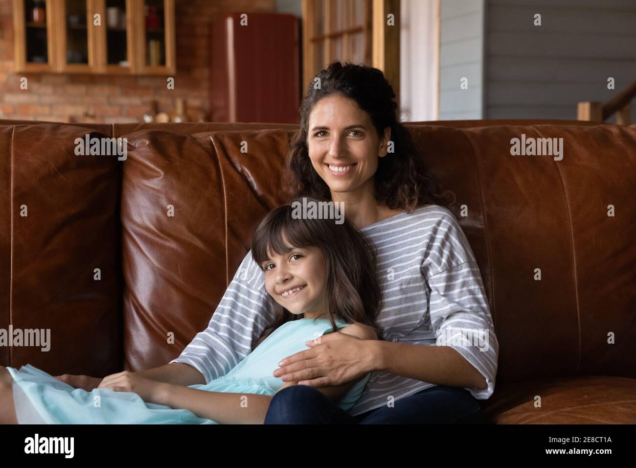 La testa ha girato il ritratto sorridendo la madre e la bambina che abbracciano Foto Stock