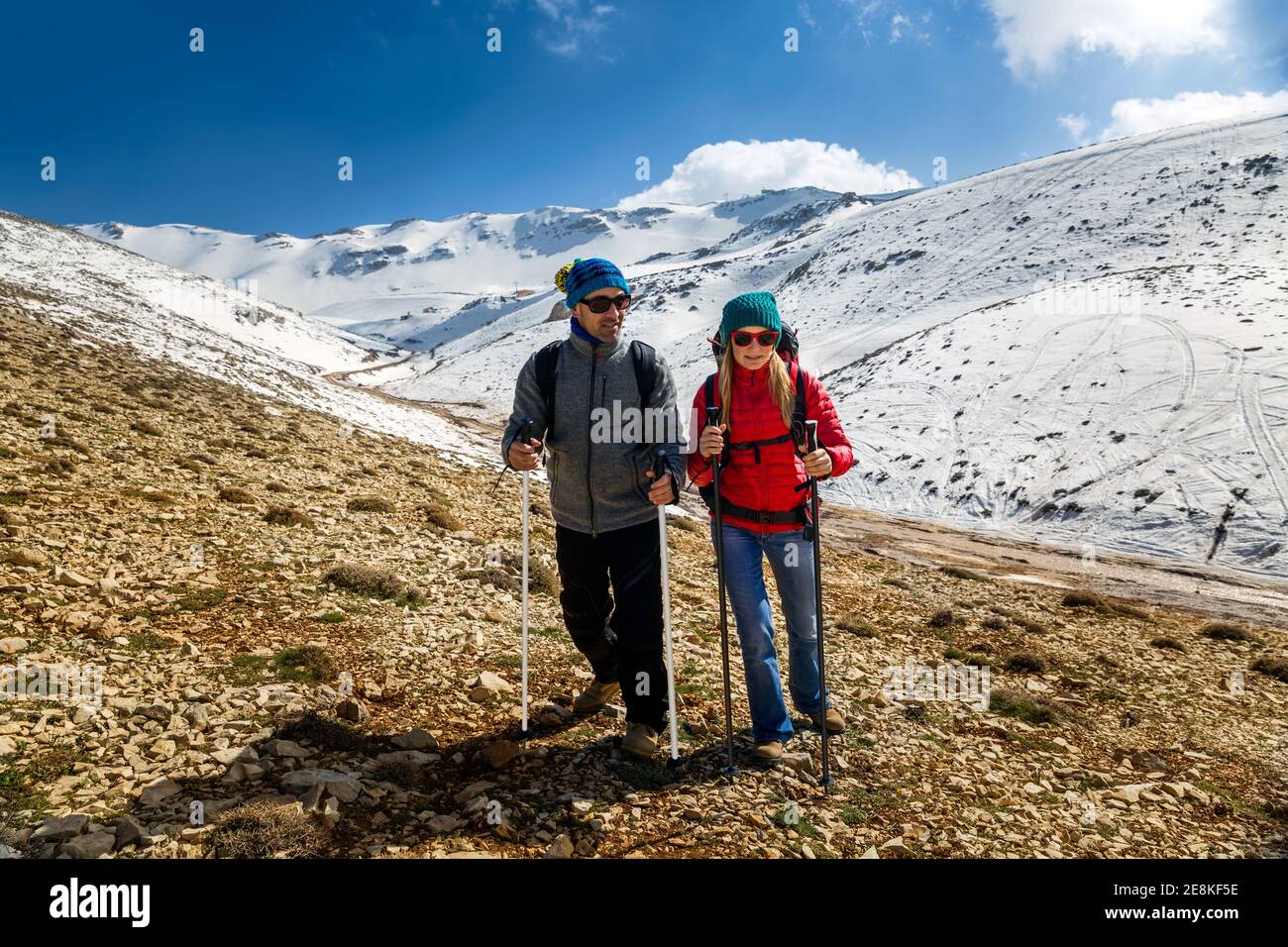 Bella coppia arrampicarsi sulla montagna con Trekking Poles. Goditi la vista incredibile. Buone Vacanze invernali attive. Sport invernale. Zest per la vita. Foto Stock