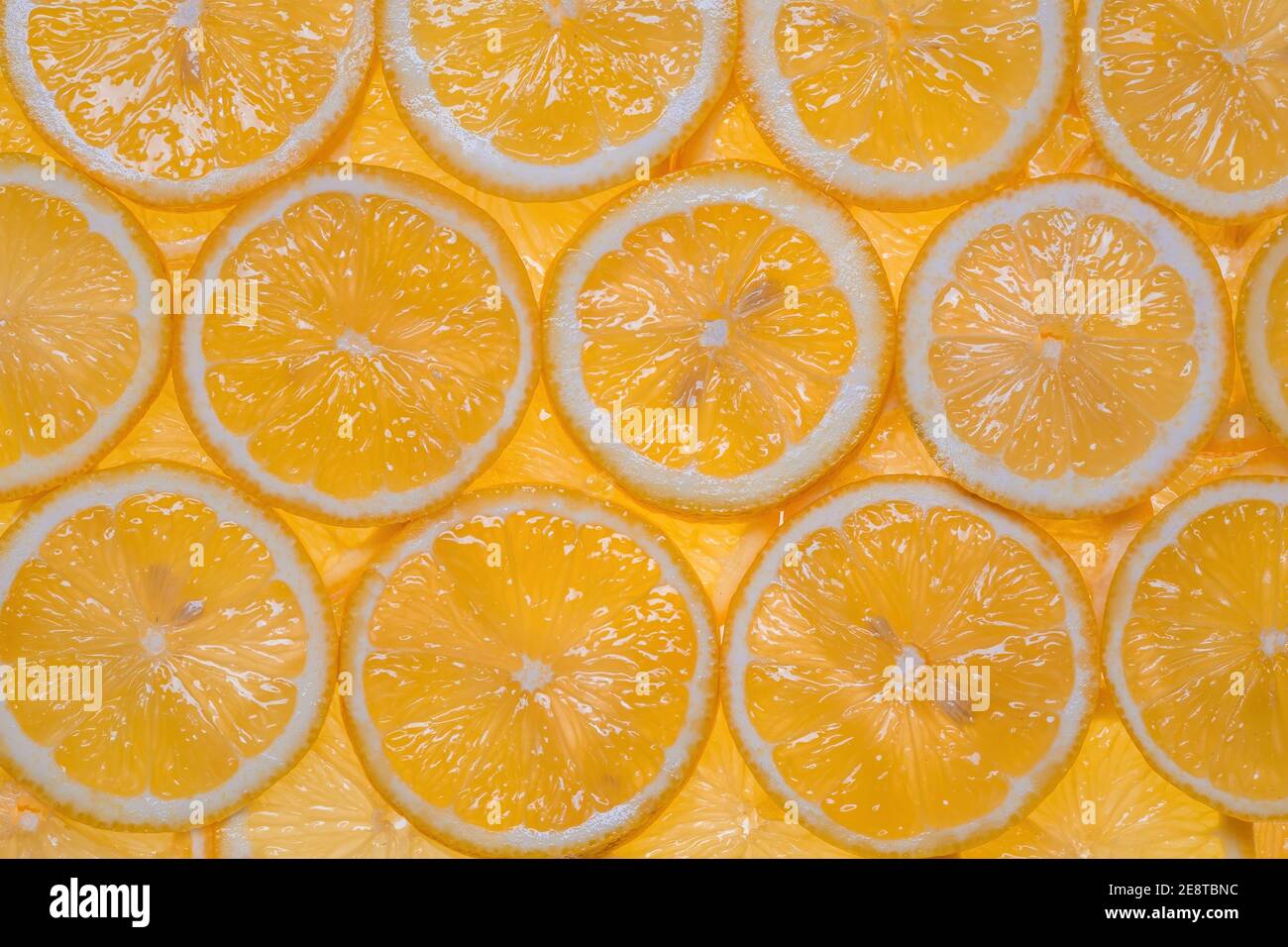Fette di limone fresco sotto acqua fondo testurizzato. Foto Stock