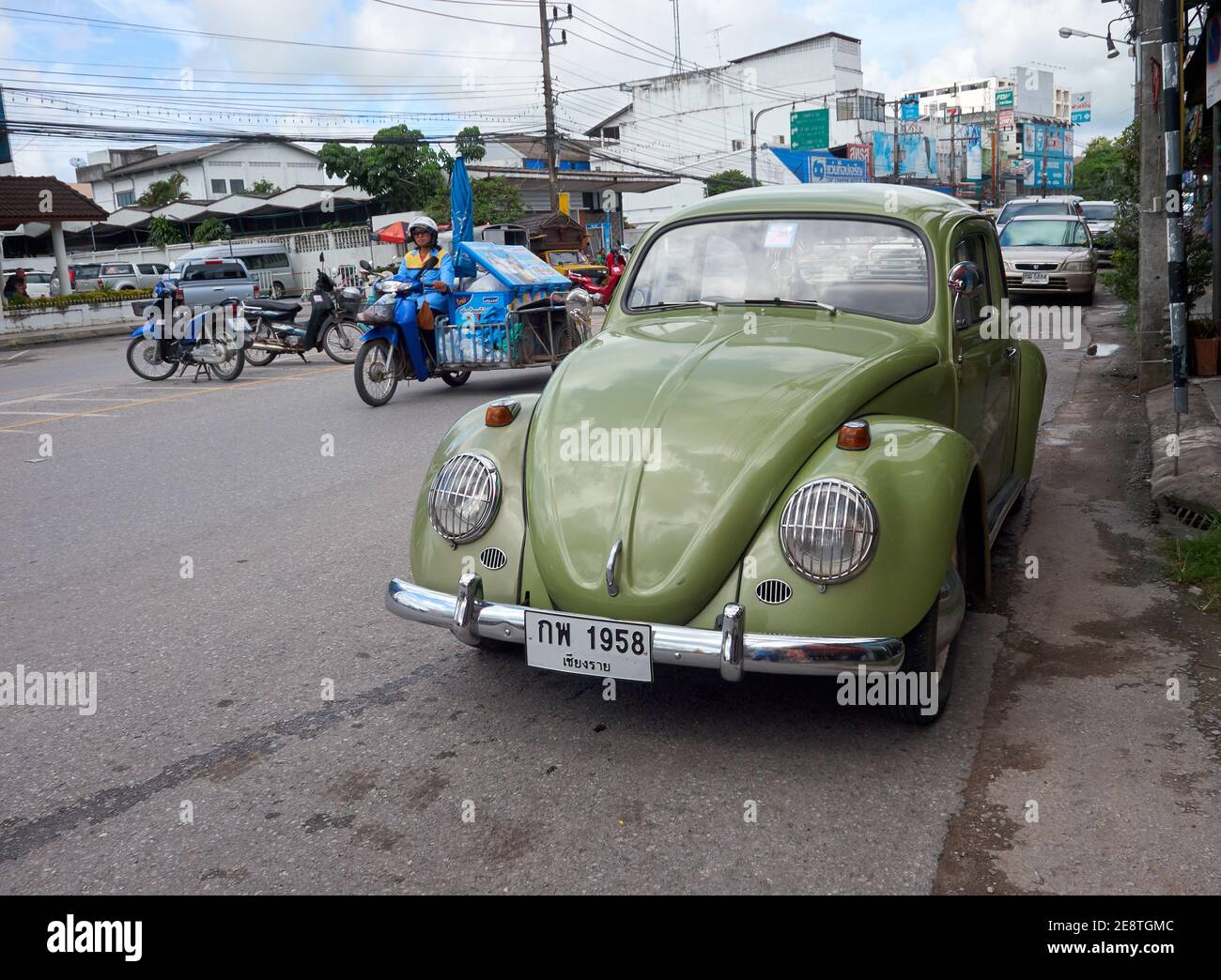 Un scarabeo volkswagen verde è parcheggiato sul lato di la strada Foto Stock