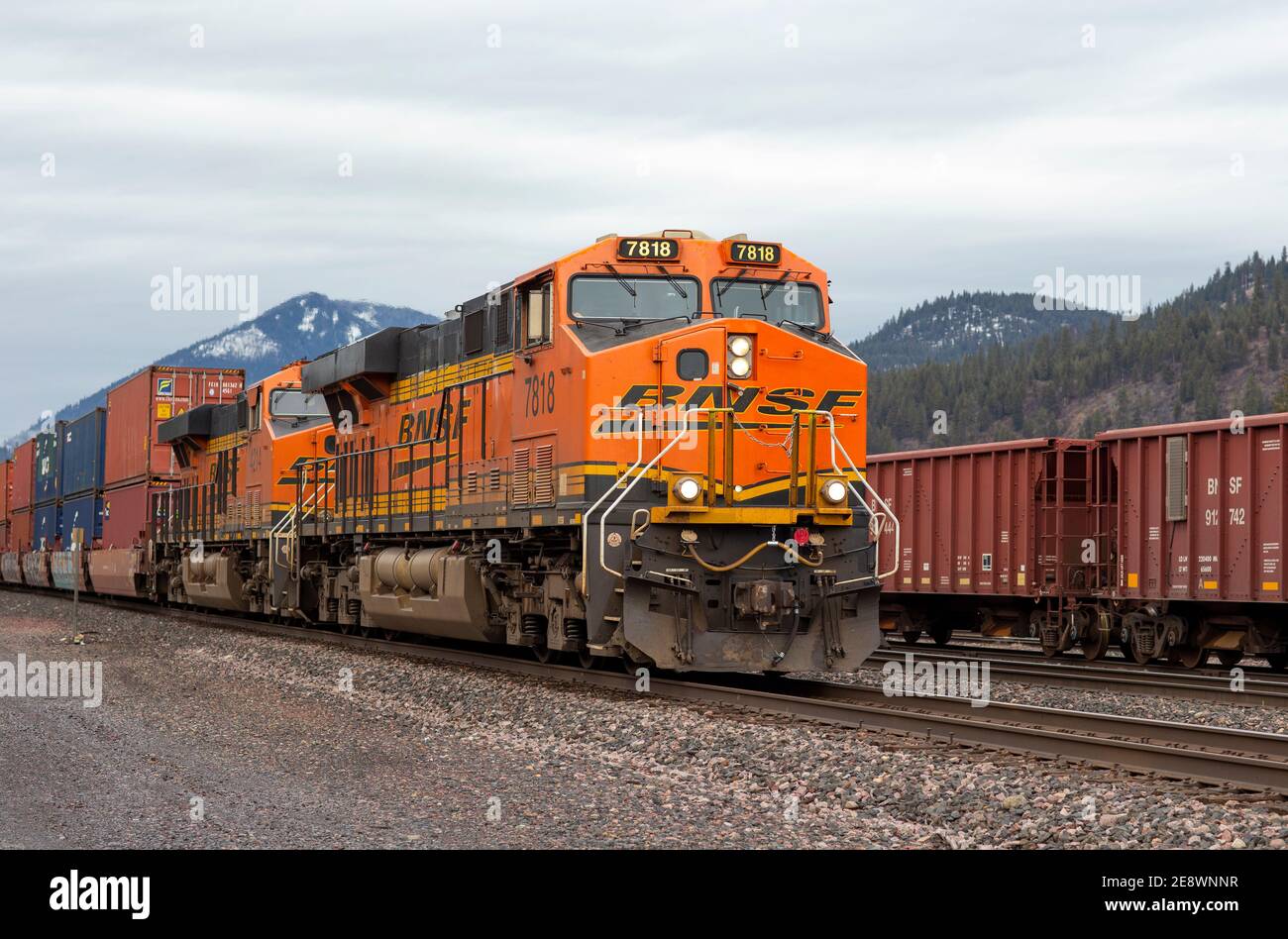 Una locomotiva elettrica diesel BNSF traina una linea di macchine per pozzi di container attraverso il cantiere ferroviario di Troy, Montana. Burlington Northern e Santa Foto Stock
