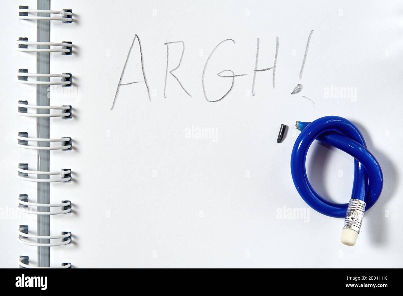 La parola furia dell'argh è scritta in blocco note e la matita è stata annodata. Concetto di emozioni e simboli Foto Stock