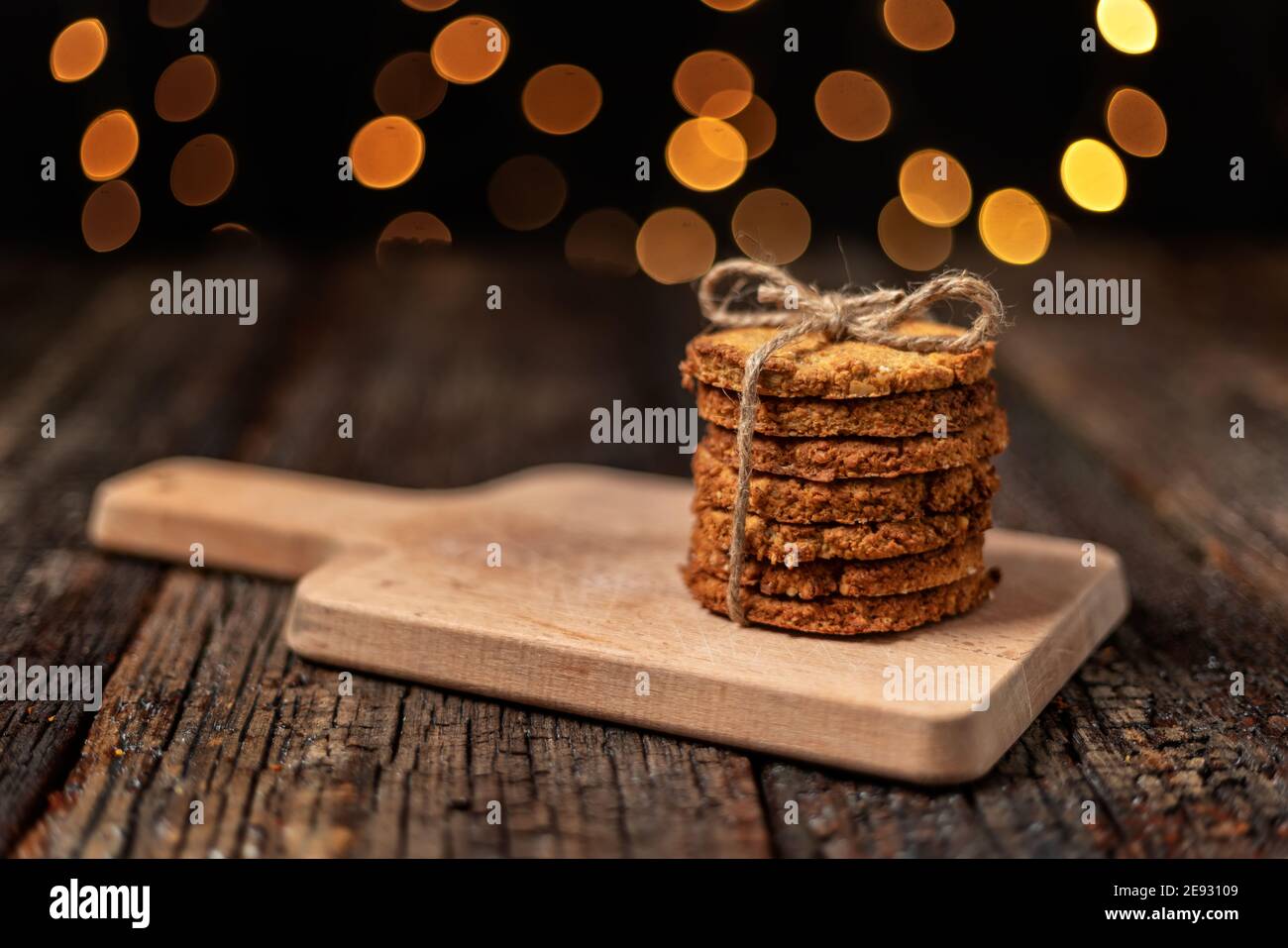Una pila di biscotti biologici d'avena per Natale, con luci di bokeh incandescenti. Primo piano. Foto Stock