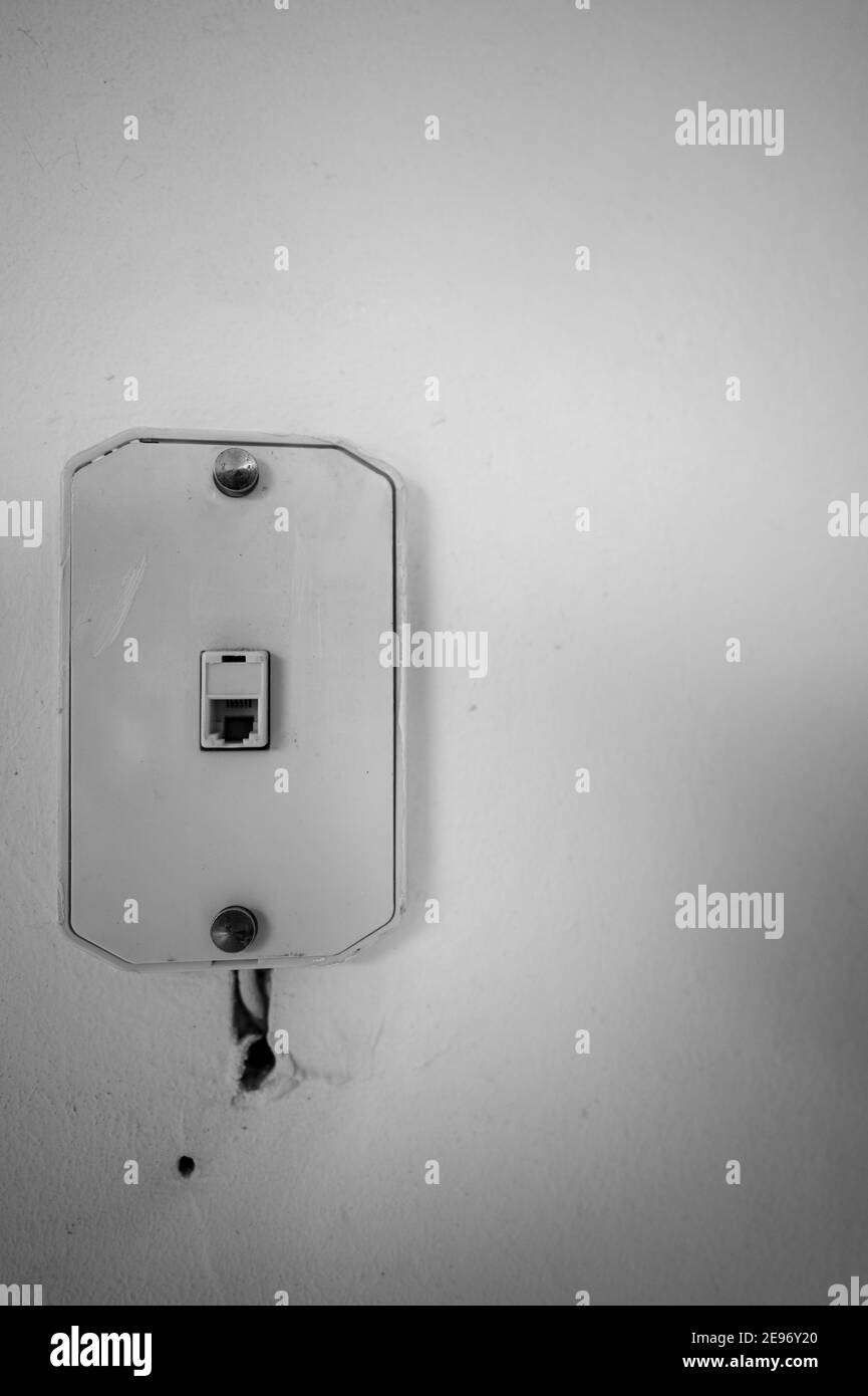 presa a muro pre-wireless e cellulare da una vecchia parete installazione Foto Stock