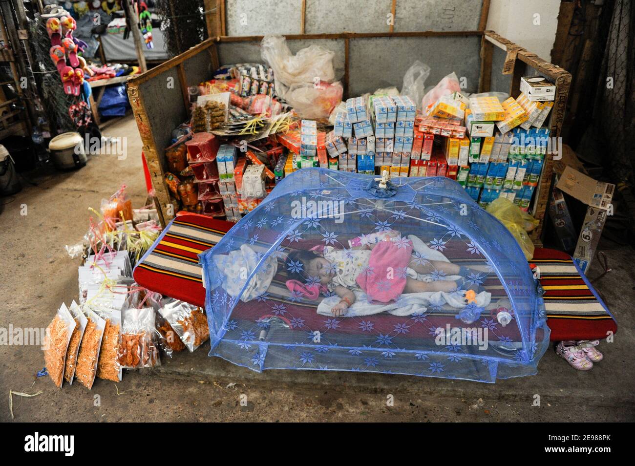 LAO PDR, Vientiane, mercato, ragazza dorme sotto zanzariera / LAOS, Vientiane, Markt, Mädchen schläft unter Moskitinetz Foto Stock