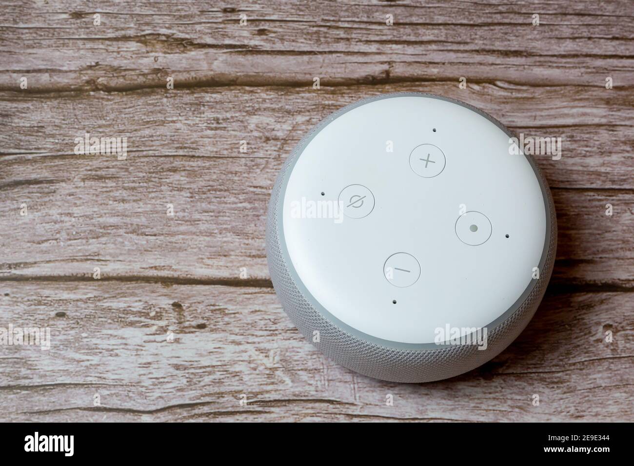 Un punto Amazon Echo o un dispositivo amazon Alexa isolato su un tavolo o una scrivania in legno Foto Stock