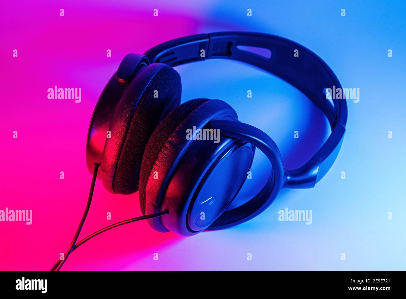 Eleganti cuffie wireless nere illuminate con coloratissima luce al neon su  sfondo astratto isolato. Concetto di tecnologia moderna con spazio di copia  Foto stock - Alamy