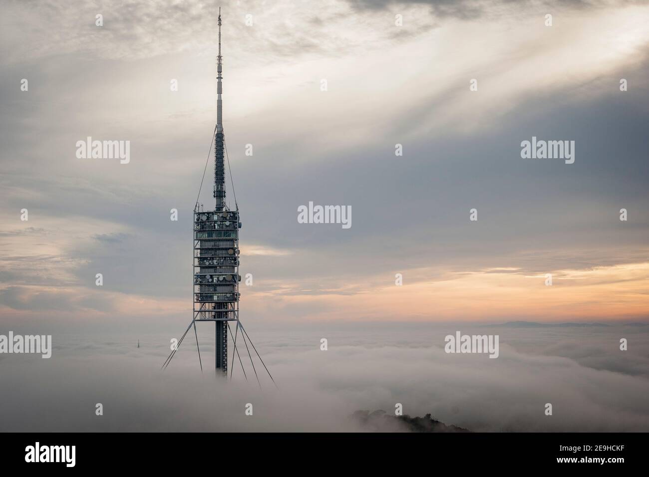 Torre delle telecomunicazioni Torre de Collserola emerge tra nuvole e nebbia sulla collina Tibidabo a Barcellona. È stato progettato dall'architetto Sir Foto Stock