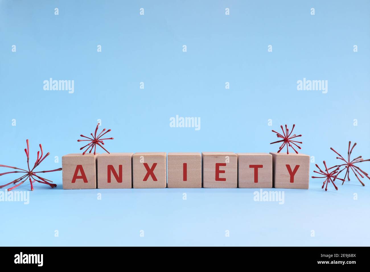 Parola di ansia in blocchi di legno su sfondo blu. Affrontare ansia, stress, ptsd e depressione durante il concetto di pandemia di covid-19. Foto Stock