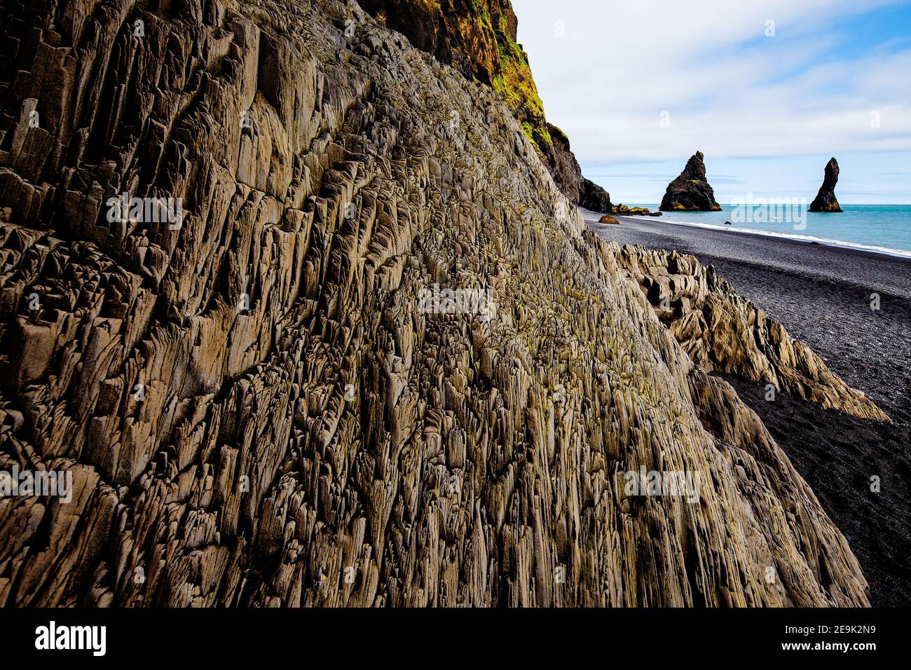 Basalt Sea Stack e le onde a Reynisfjara Beach. Costa Sud dell'Islanda. Foto Stock